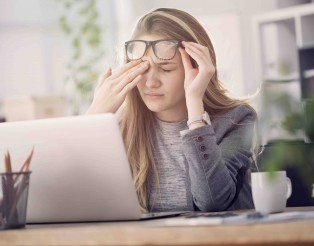Young tired working woman at work